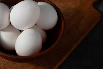 raw beautiful chicken eggs in a clay plate