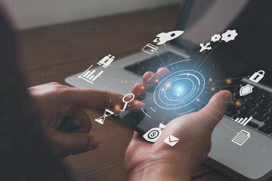 Businessmen holding a smartphone with icons of AR virtual screen dashboard with project management with icons of scheduling, budgeting, communication.