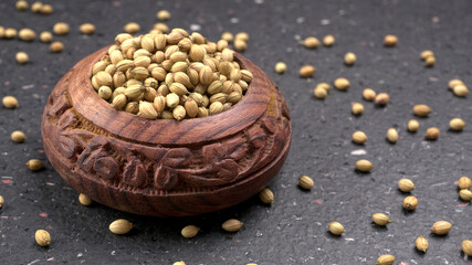 Dry coriander seeds with small bamboo spoon and green fresh bunch coriander leaves,famous spices ingredients in asia's kitchen.