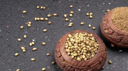 Dry coriander seeds with small bamboo spoon and green fresh bunch coriander leaves,famous spices ingredients in asia's kitchen.