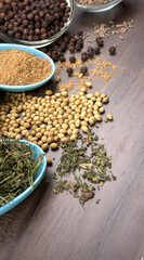 Dry coriander seeds with small bamboo spoon and green fresh bunch coriander leaves,famous spices ingredients in asia's kitchen.