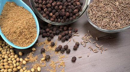 Dry coriander seeds with small bamboo spoon and green fresh bunch coriander leaves,famous spices ingredients in asia's kitchen.