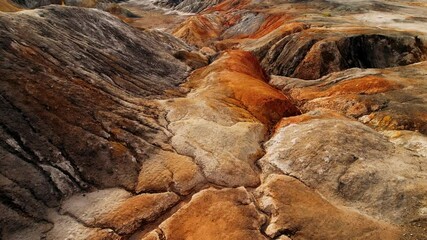 Orange soil is contaminated with heavy metals from an industrial plant. Chemical pollution of soil, toxic waste. Concept of environmental disaster and habitat destruction.