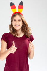 Modern Lifestyle Concepts. Caucasian Teenage Girl Posing With Head Band Demonstrating German Flag and Posing Against White Background.