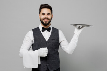 Young barista male waiter butler man wear white shirt vest elegant uniform work at cafe hold in...