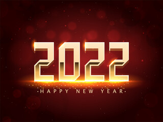 Golden 2022 Happy New Year Font With Light Effect On Red Bokeh Effect Background.