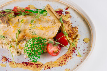 White fish with cuscus and vegetables on white background