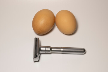 A creative concept with eggs and a razor.   Selective focus.