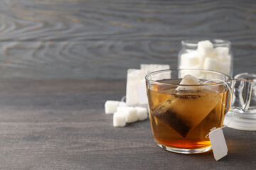 Concept of hot drink with tea on gray wooden table