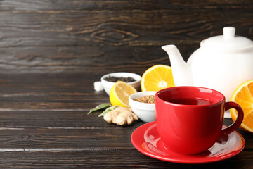 Concept of hot drink with tea on dark wooden table