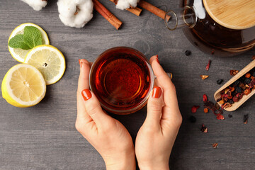 Concept of hot drink with tea on gray wooden background