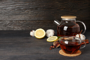 Concept of hot drink with tea on dark wooden table