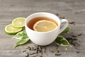 Concept of hot drink with tea on gray wooden background