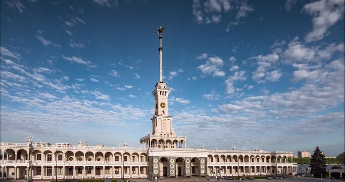 Clouds flying fast over the building with the clock on the river embankment