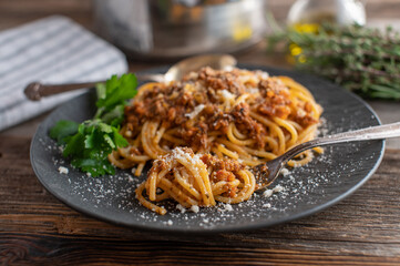 Spaghetti Bolognese on a dark plate