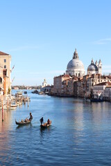 Beautiful view of Grand Canal with Venetian gondolas on a sunny day in Venice, Italy