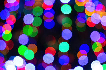 Abstract bokeh lights with soft light background. Festive abstract christmas texture, golden bokeh particles and highlights on dark background.