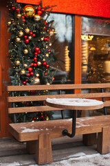 christmas table in a restaurant terrace outside in winter with xmas decorations