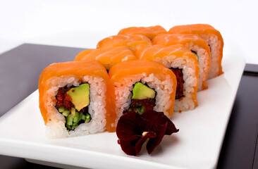 Sushi rolls Japanese delicacies. Japanese traditional rice and fish dishes. Beautiful serving food on a light background with copy space. A set of delicious goodies.