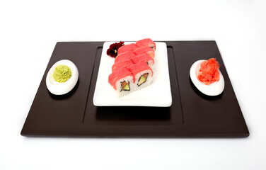 Sushi rolls Japanese delicacies. Japanese traditional rice and fish dishes. Beautiful serving food on a light background with copy space. A set of delicious goodies.