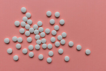 Pile of pills on pink background, supplement, medicine, pandemic concept. Closeup, copy space