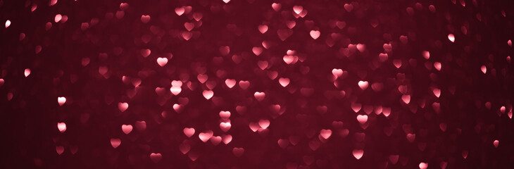 Background bokeh in the form of hearts of red and pink color. Copy space for text. The concept of...