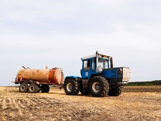 Tractor with tank trailer in the field
