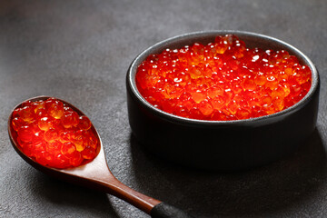 Red caviar in a cup and spoon