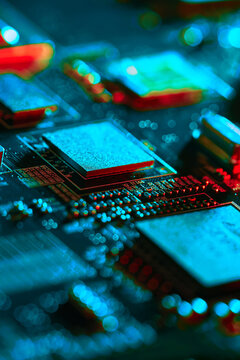 Electronic circuit board with electronic components such as chips close up. Blurry background.