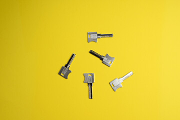 Set of door keys on a colored background, top view, flat lay. Conceptual composition.