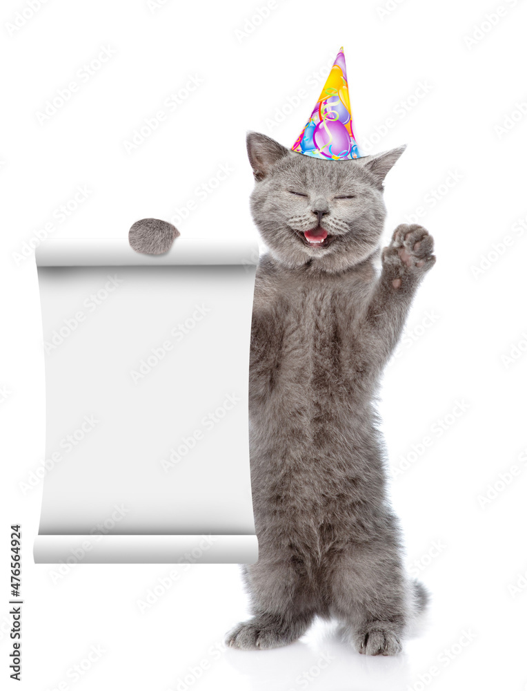 Poster happy cat wearing birthday cap shows empty list. isolated on white background