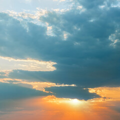 Dramatic sunset view with storm clouds.