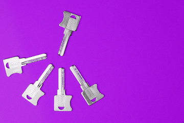 Keys on a colored background, top view. Fashionable colorful photo. Trendy flat lay concept.