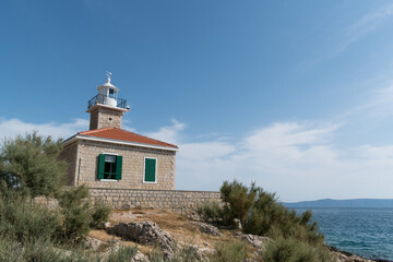 Fototapeta na wymiar Lighthouse St. Peter on the St. Peter peninsula in Makarska, Dalmatia, Croatia during summer