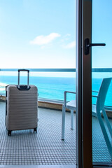 Beige Suitcase on balcony ocean view in luxury beach hotel in  tropical country .Copy space