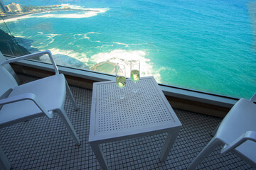 Two champagne glass on the table in hotel balcony with sea view in  tropical country