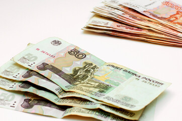 Russian money on a neutral background. Poverty, inflation, saving money.
