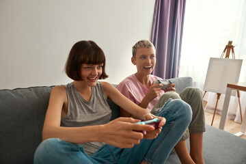 Young excited lesbian girls playing video game