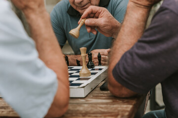two men playing chess outdoor park in summer 