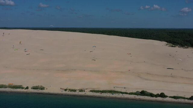  Paragliders fly over the Dune of Pilat Dune du Pilat , Arcachon, France. Largest sand dune in Europe.
