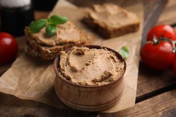 Bowl with delicious meat pate on wooden table, closeup