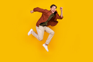 Fototapeta na wymiar Full length profile side photo of young man good mood jumper runner isolated over yellow color background