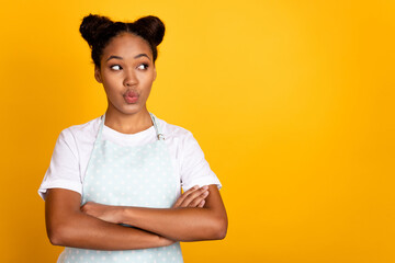 Photo of young pretty african lady folded hands interested look empty space think isolated over...