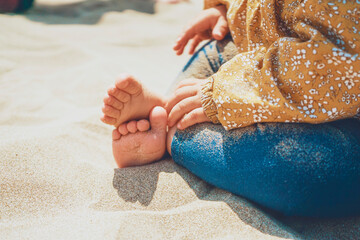 Close up of legs and feet of a baby sitting over the sun