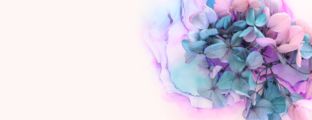 Creative image of pink and turquoise Hydrangea flowers on artistic ink background. Top view with copy space