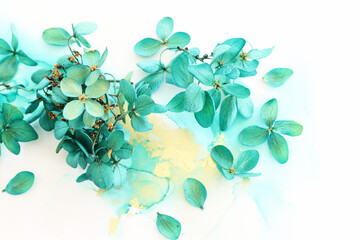 Creative image of emerald and green Hydrangea flowers on artistic ink background. Top view with...