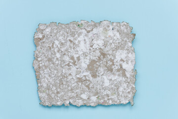 Fragment of recycled paper. Texture, background. Paper elements are clearly visible. The concept of an environmentally friendly attitude to the environment. View from above.