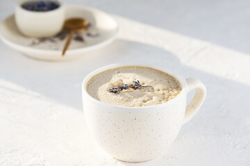 Raf coffee with lavender syrup in a white mug. Sugar, gluten and lactose free and vegan.