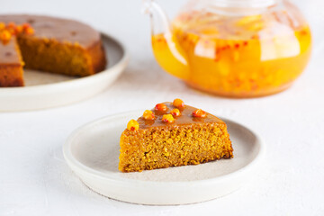 A piece of sea buckthorn pie with orange on a plate. Sugar, gluten and lactose free and vegan.