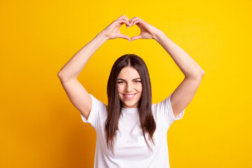 Obraz na płótnie Canvas Photo of young attractive girl show fingers heart symbol feelings love romance isolated over yellow color background